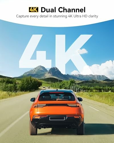 Orange car on road with 4K text and mountains